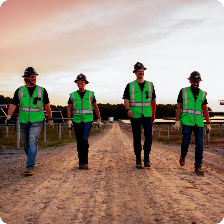 four employees walking on project site