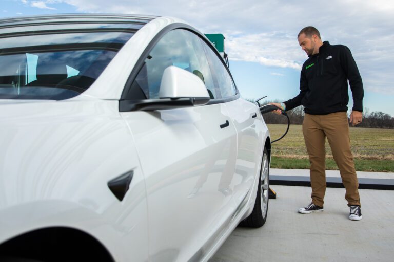 Man using Shoals EV charging solution on electrical vehicle